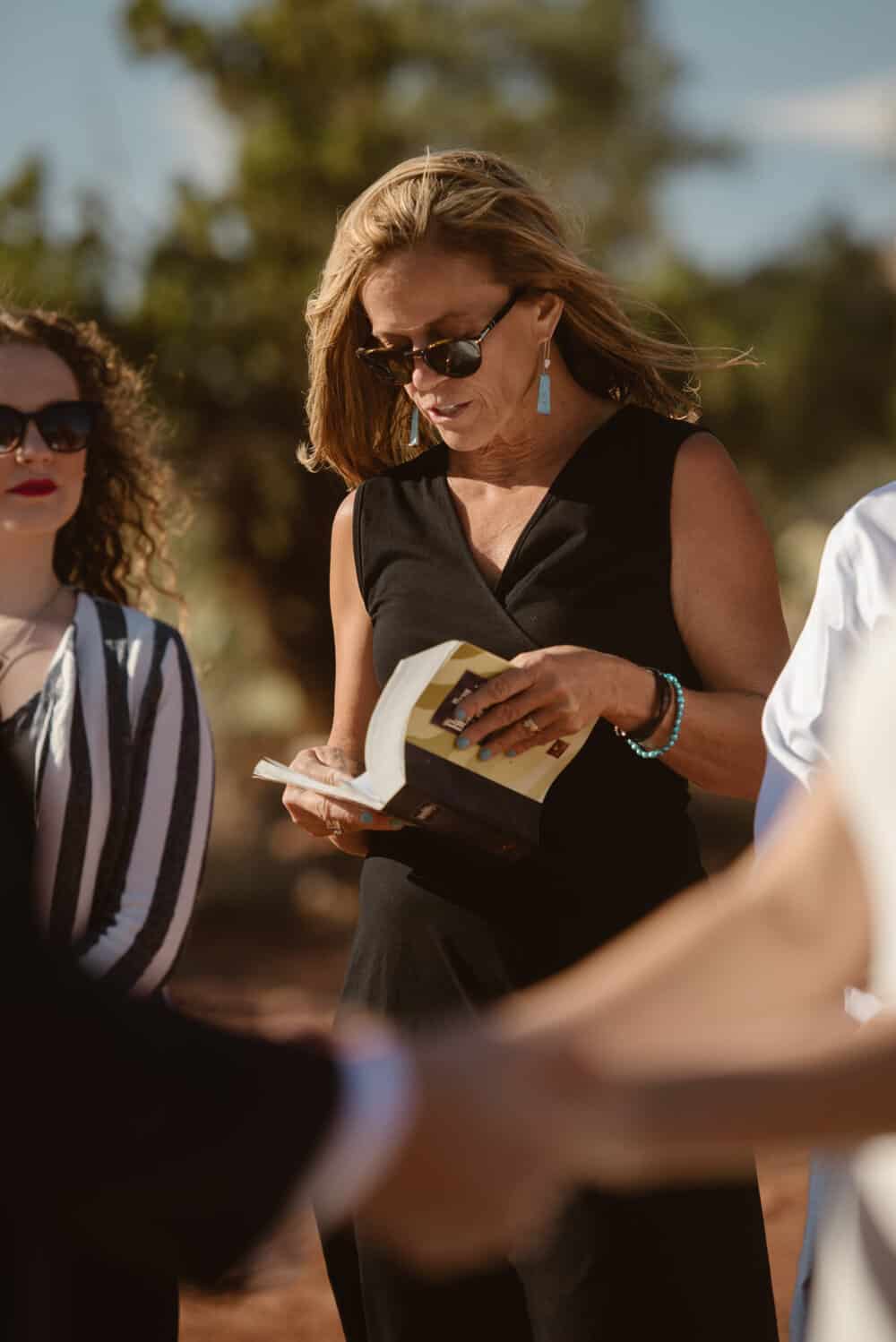 The brides mom reads a versus from the bible during the ceremony. 