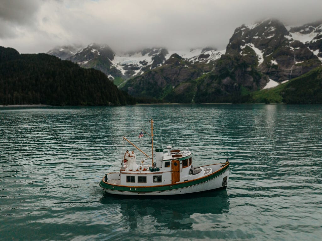 Two brides on a private vintage boat tour near a glacier in Seward.