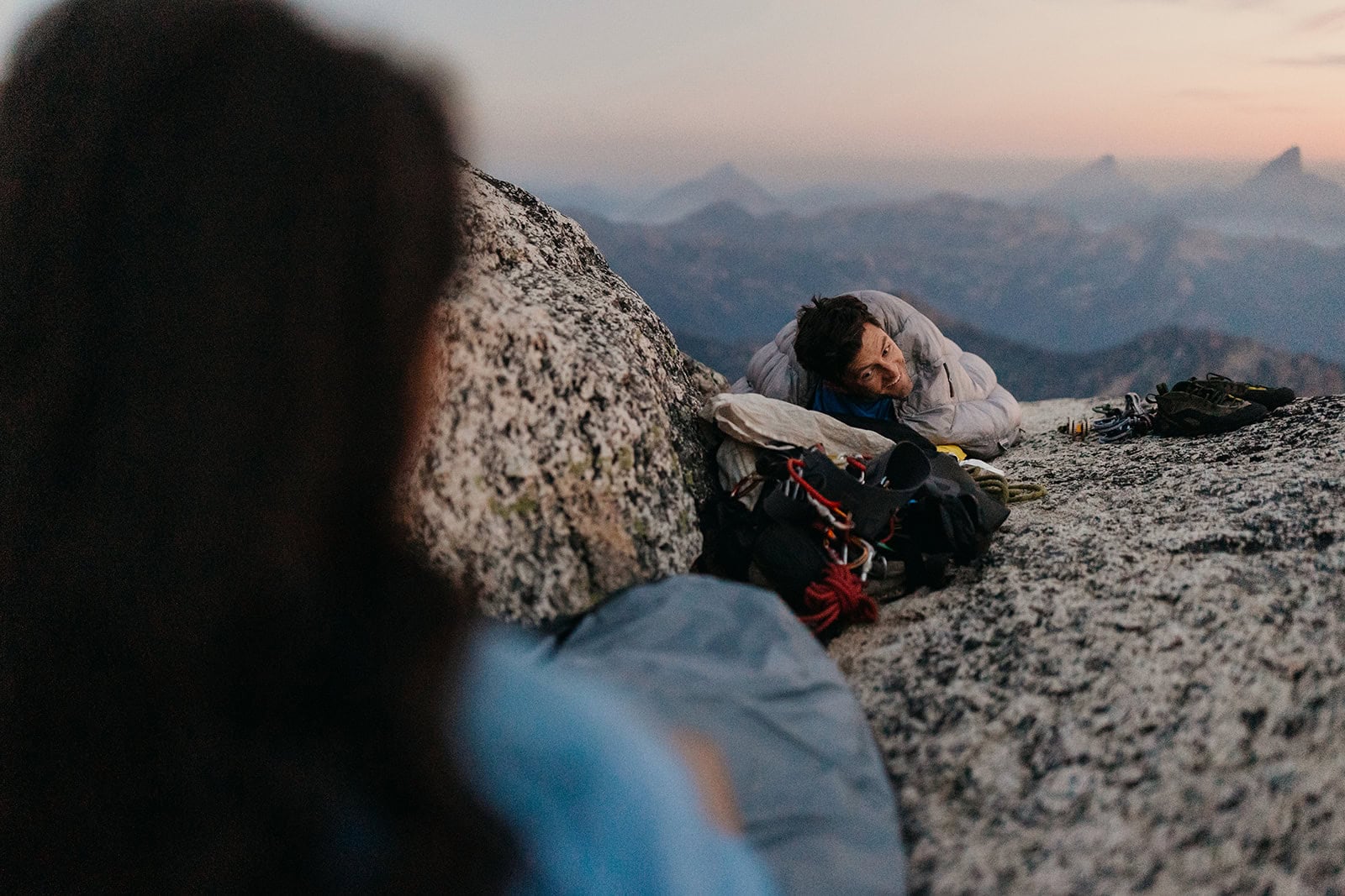 A shot of someone looking at someone else in a sleeping bag