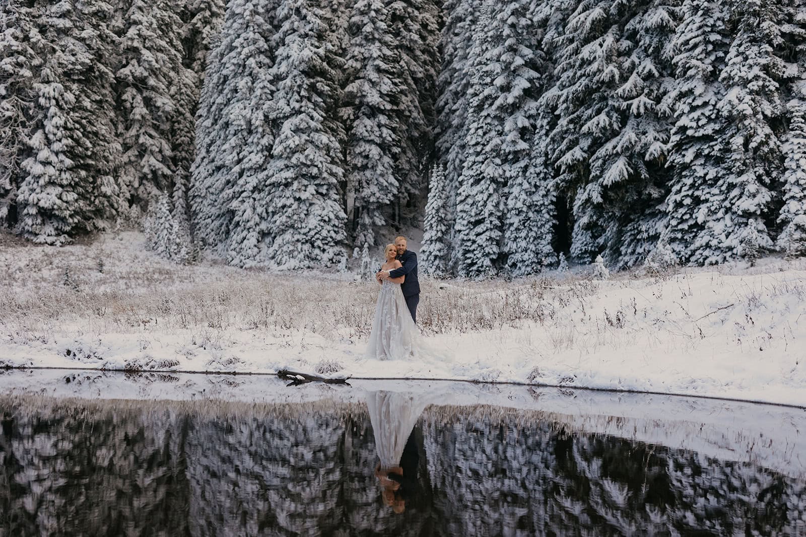 A couple walks through the snow in Mt Rainier National Park