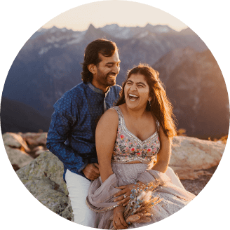 A couple sitting close together laughing 