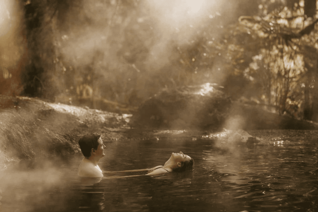 A bride dips her hair back into a hot spring one spring morning near Baker Lake.