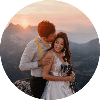 A person standing behind their partner and kissing them on the cheek